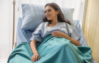 woman laying in an in-home hospital bed