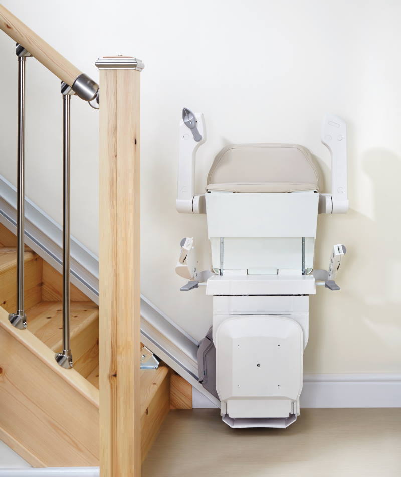 Narrow folded affordable stairlift at bottom of Milwaukee stairs